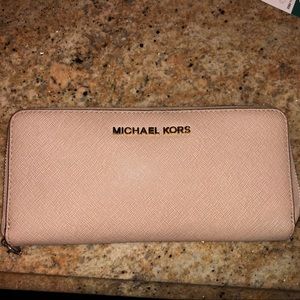Slightly used Michael Kors continental wristlet.